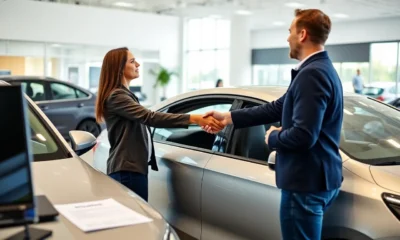 Customer shaking hands with car dealer in a modern showroom with embedded auto insurance documents on table