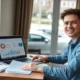 Young adult managing pay-per-mile car insurance from home with parked vehicle outside